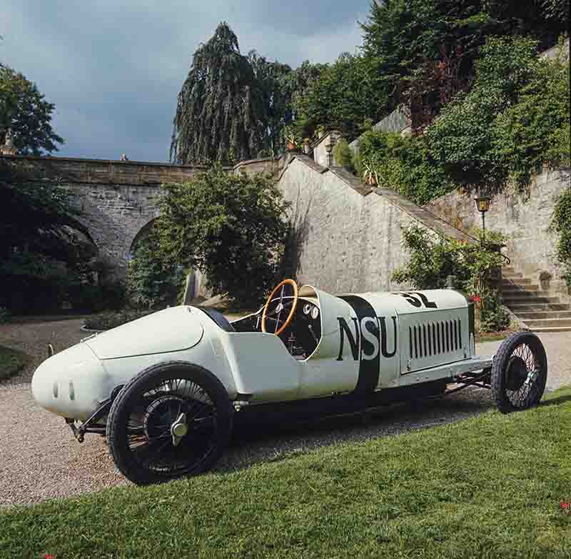 NSU Racing Car parked on a grassy area, showcasing its classic design against a natural backdrop.
