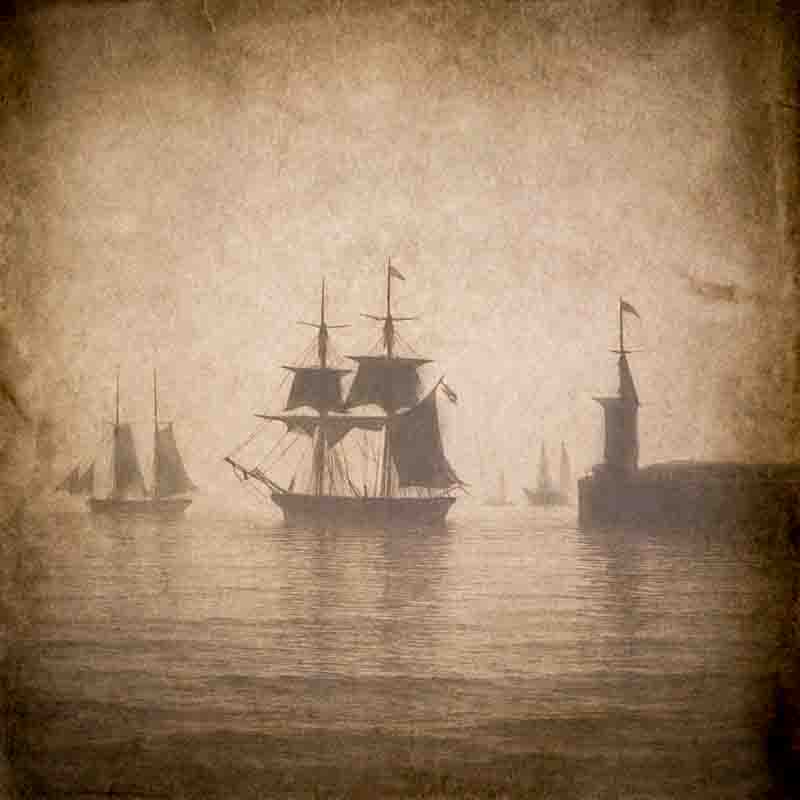 A sepia-toned, aged wax paper negative photograph depicts several sailing ships on a calm body of water, shrouded in a soft, misty atmosphere. In the center, a large, multi-masted ship with furled sails is prominently silhouetted.